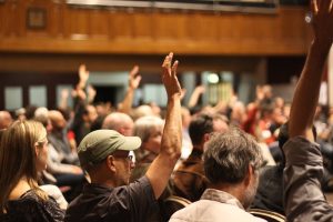 Hands raised by participants in a previous Transition Network UK conference held at Battersea Arts Centre in London